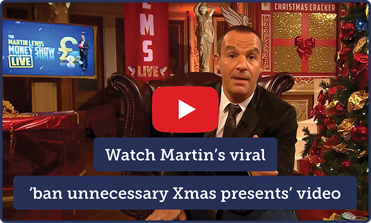A still taken from Martin's TV show, showing him sitting on a chair in a festive room. In the centre is a YouTube-style 'play' button, beneath which overlaid text reads: "Watch Martin's viral 'ban unnecessary Xmas presents' video." The link takes you to Martin's blog, where you can watch or listen to the video itself.